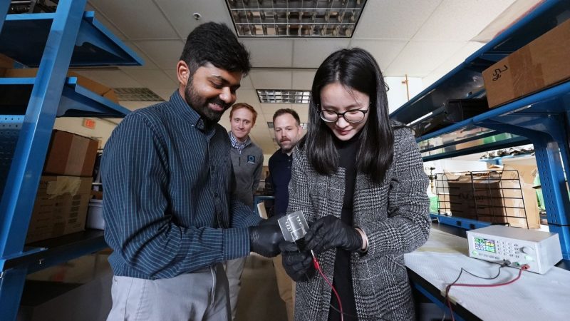 (From left) Ravi Tutika, Michael Bartlett, Josh Worch, and Meng Jiang test the recyclable circuit created by the teams from mechanical engineering and chemistry. Photo by Alex Parrish for Virginia Tech.